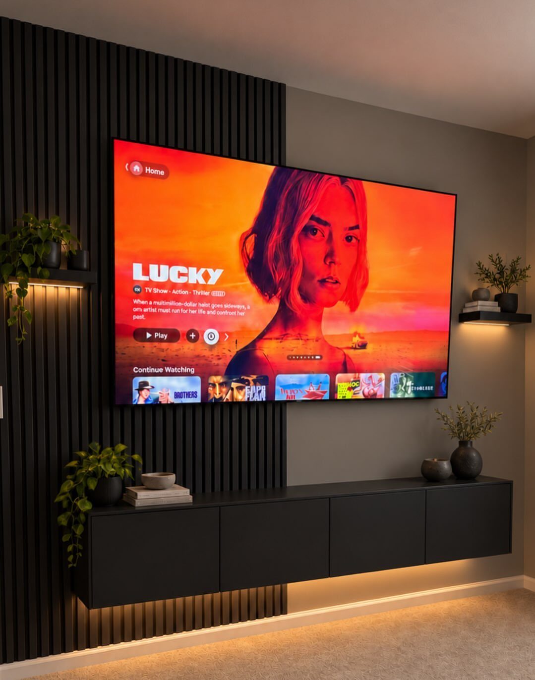 21 Living Room TV Unit Designs Luxury Homes Need in 2026 3 Wall-mounted TV on a black slatted wall with a floating black storage console.