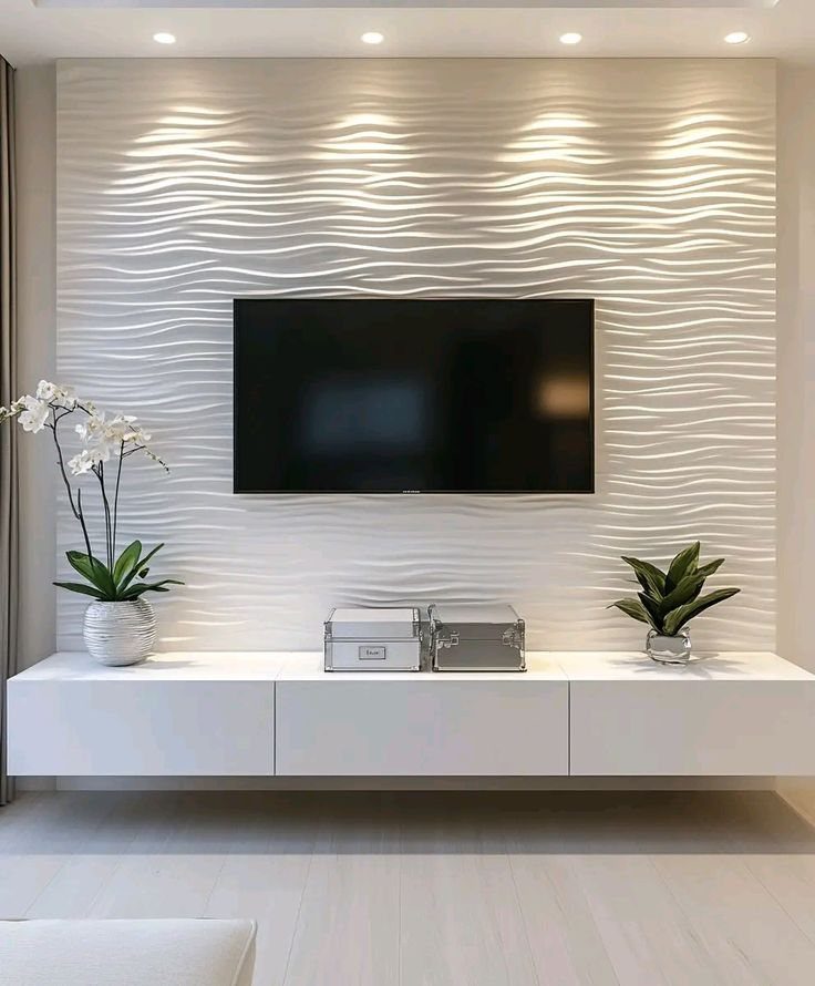 Modern white floating TV unit against a luxury 3D wavy textured wall.